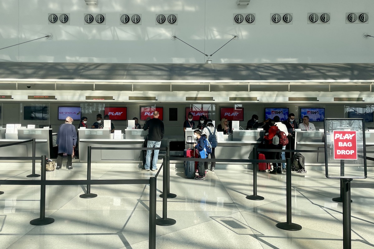 Travelers check-in for Play Airlines flights