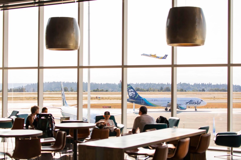 view through an airport lounge to an airline on the tarmac