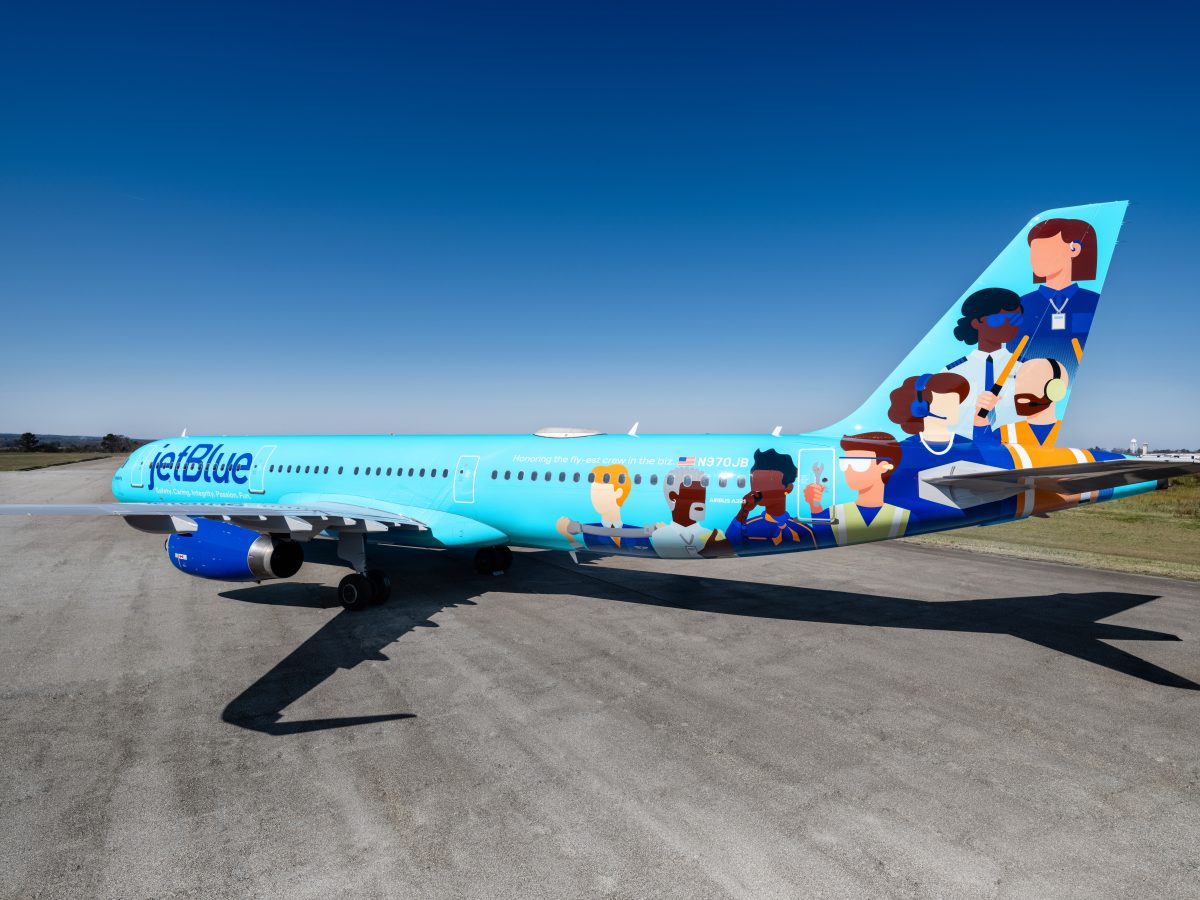 JetBlue's new 'BlueUnity' livery aircraft is parked on the apron.