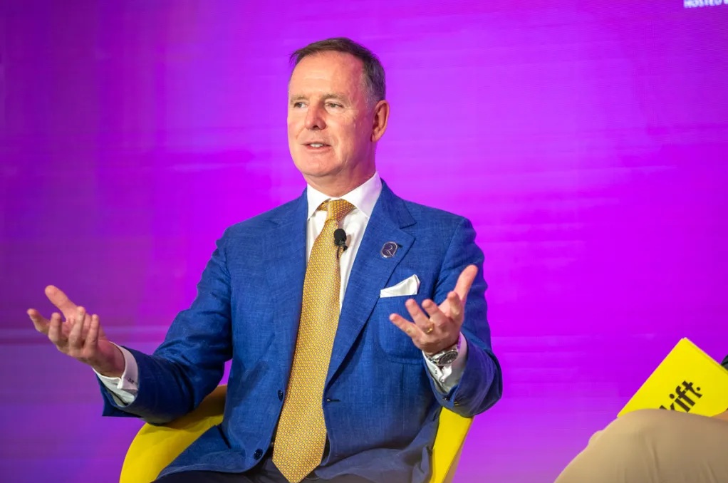 Tony Douglas, CEO of Riyadh Air speaking on stage at a Skift event.