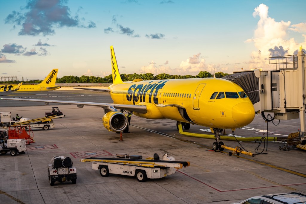 A Spirit Airlines plane at an airport gate.